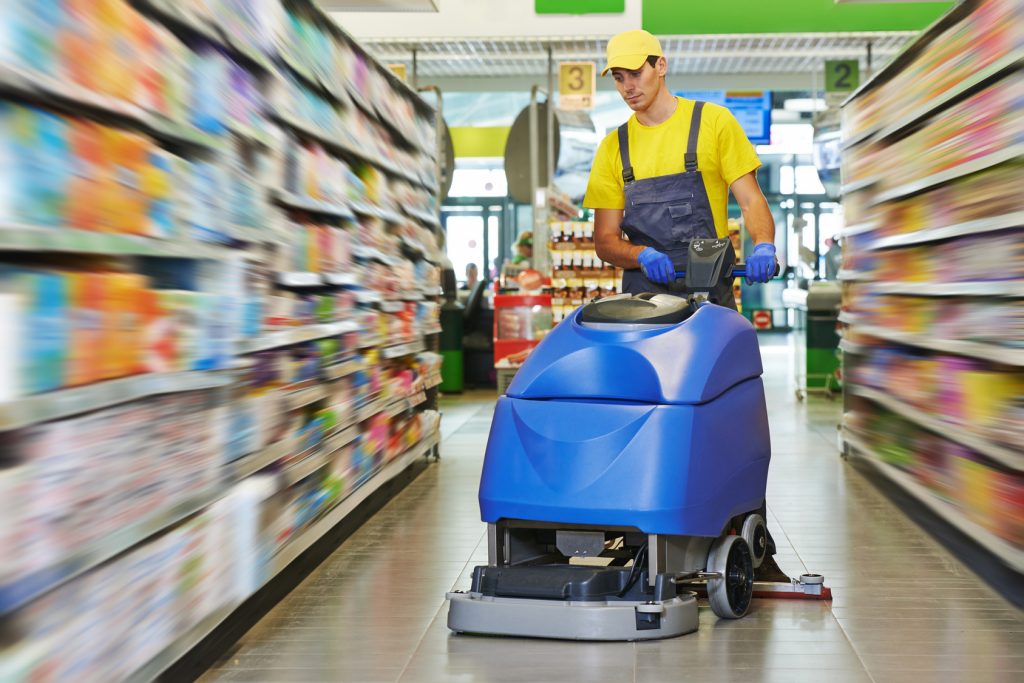 Floor care and cleaning services with washing machine in supermarket shop store